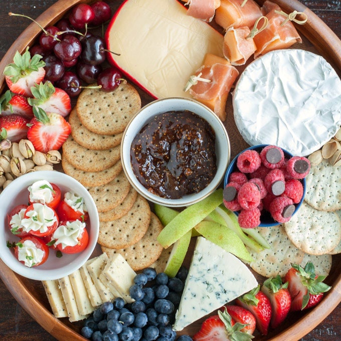 Plate with crackers, fruit and cheese.