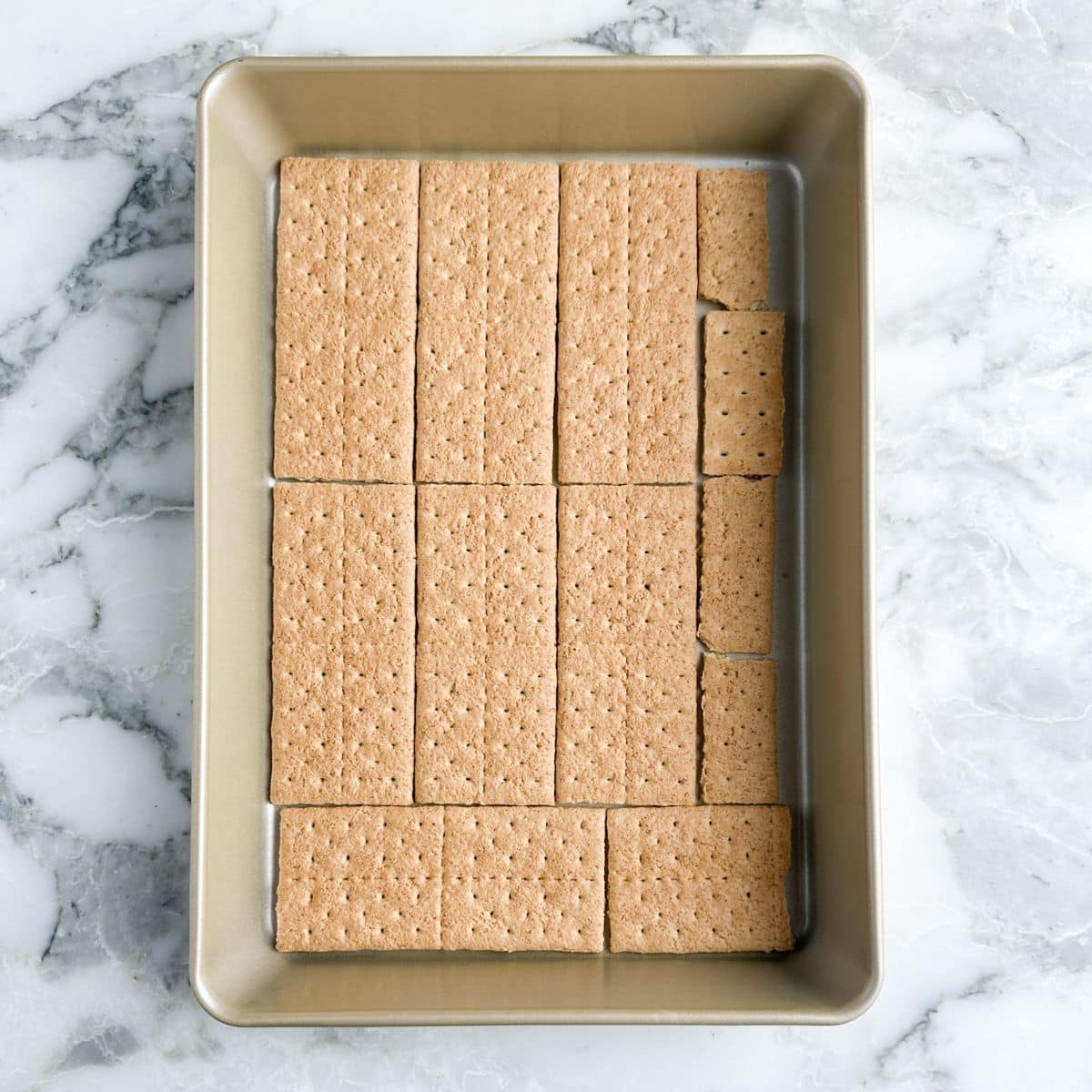 Baking dish lined with graham crackers. 