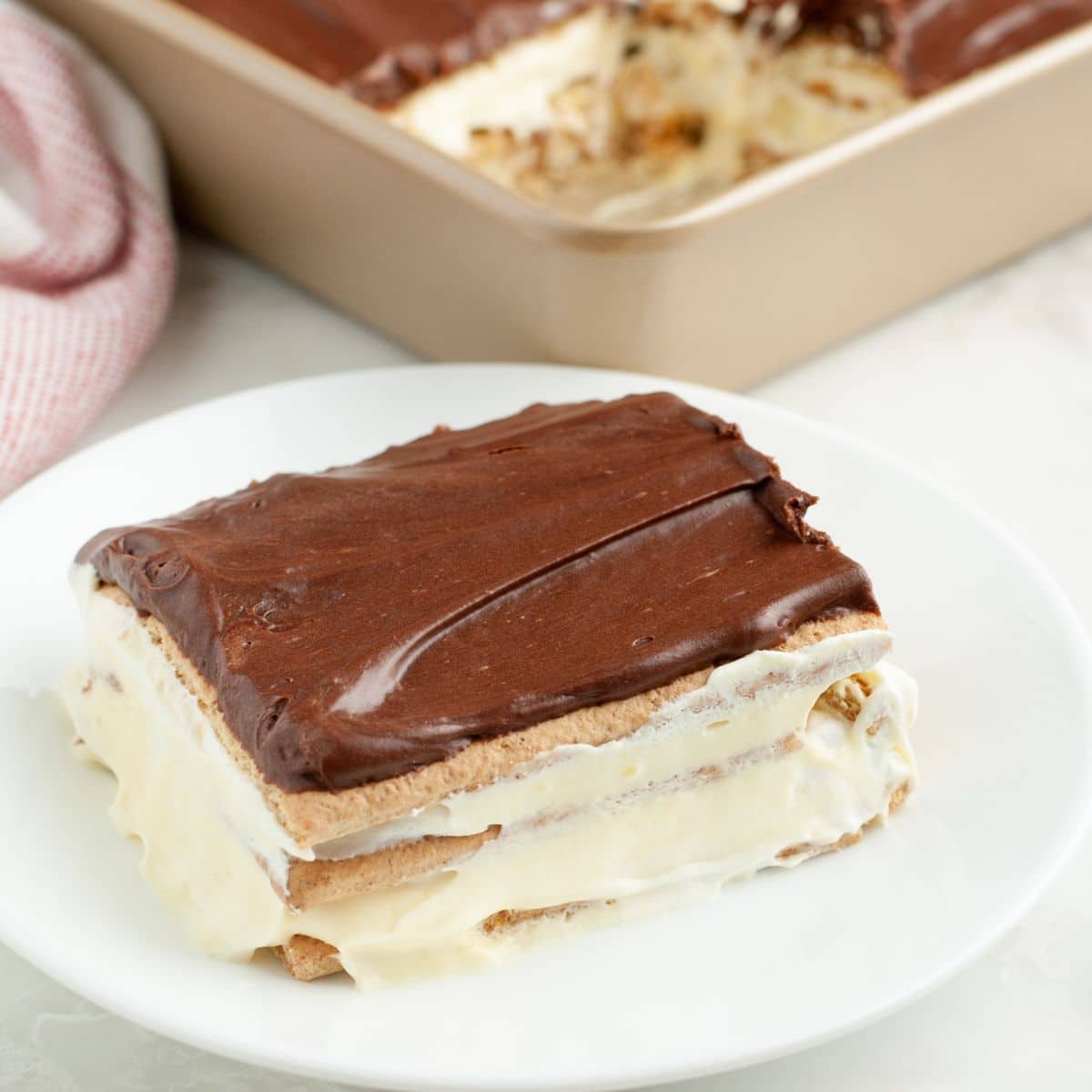 Piece of eclair cake on a plate. 