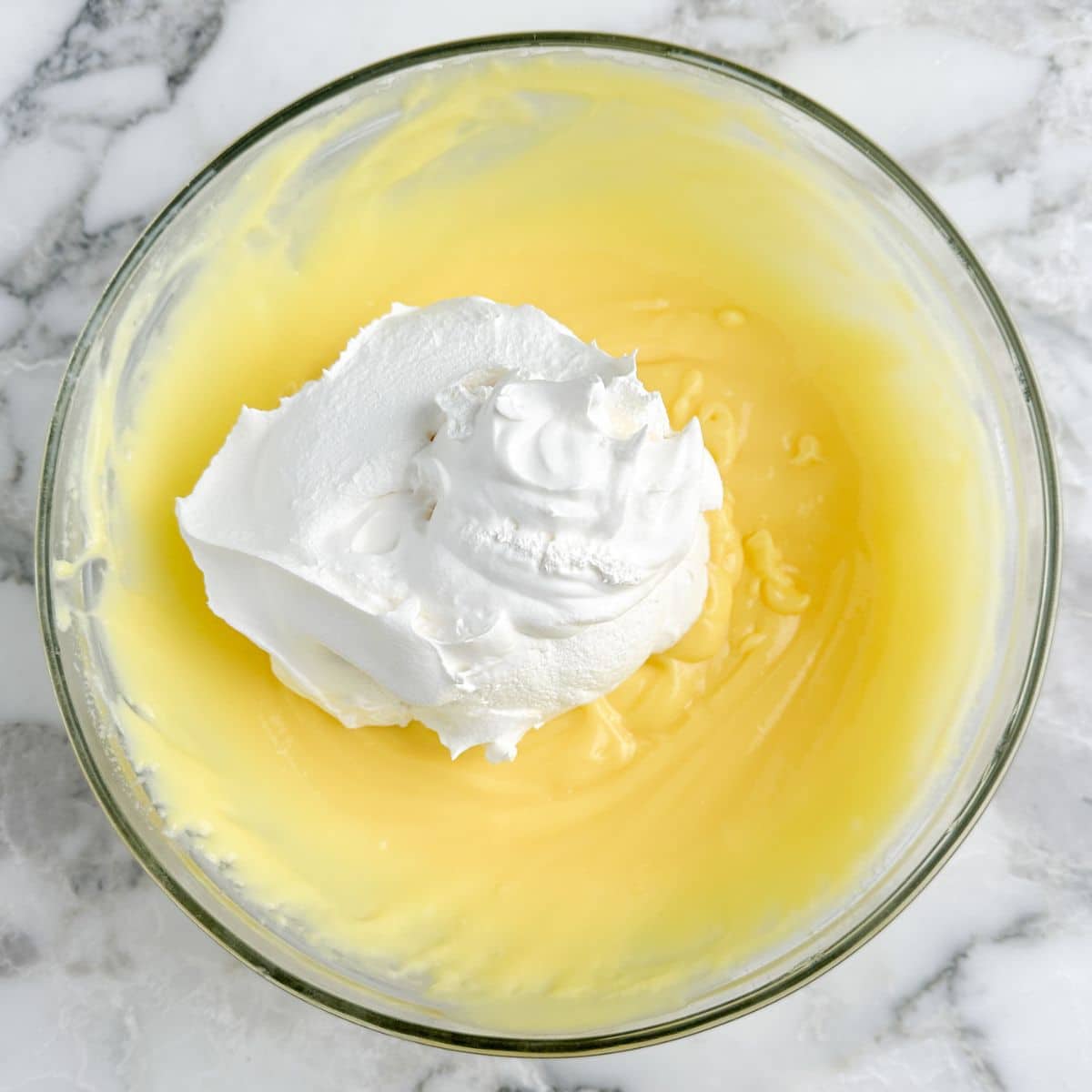 Bowl with vanilla pudding and Cool Whip. 