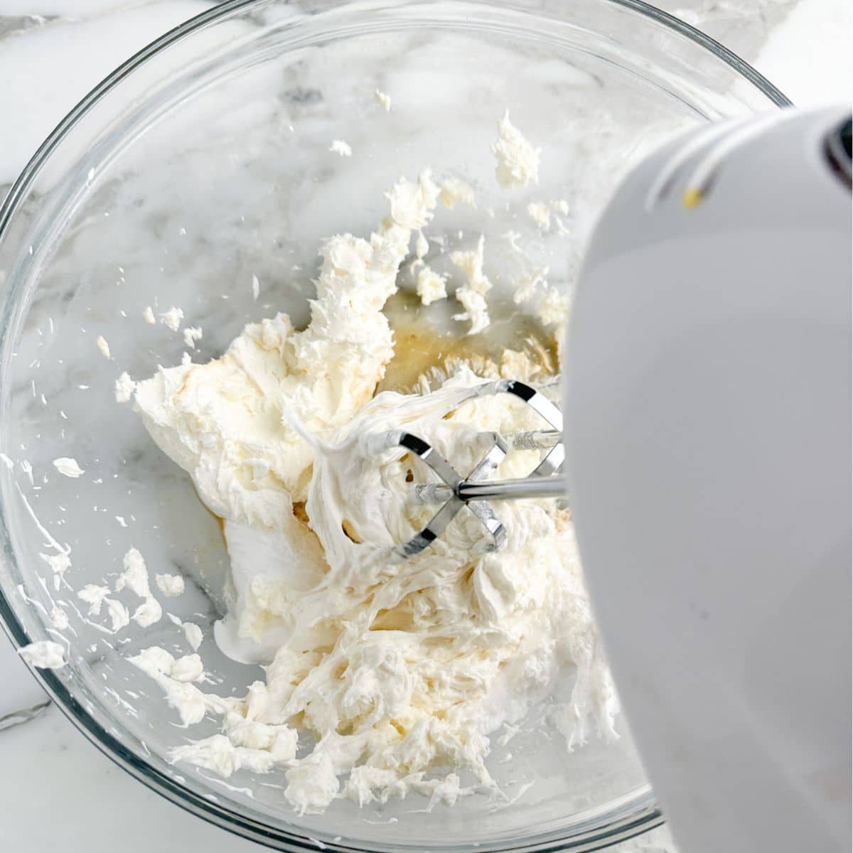 Mixer creaming cream cheese.