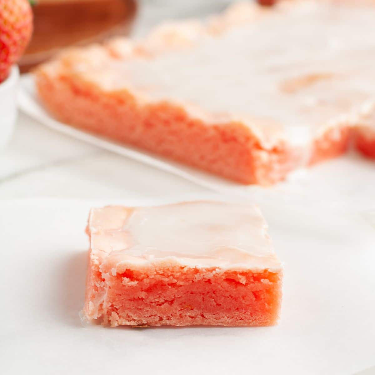 Piece of strawberry bar with glaze on top. 