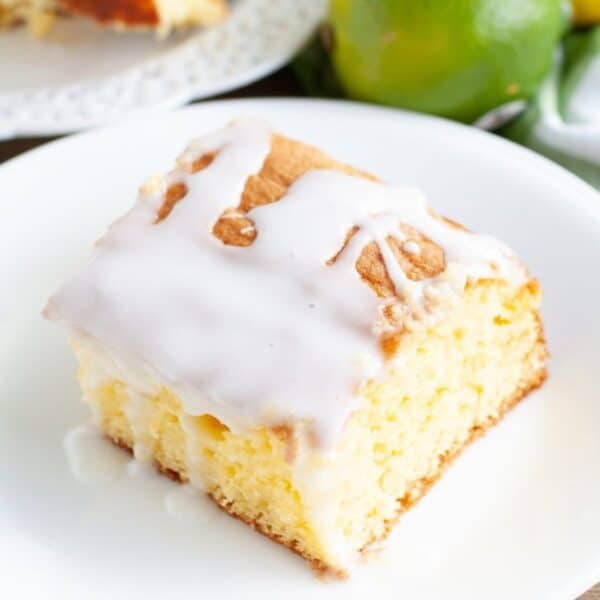 Piece of 7-up cake on a plate with a lime.