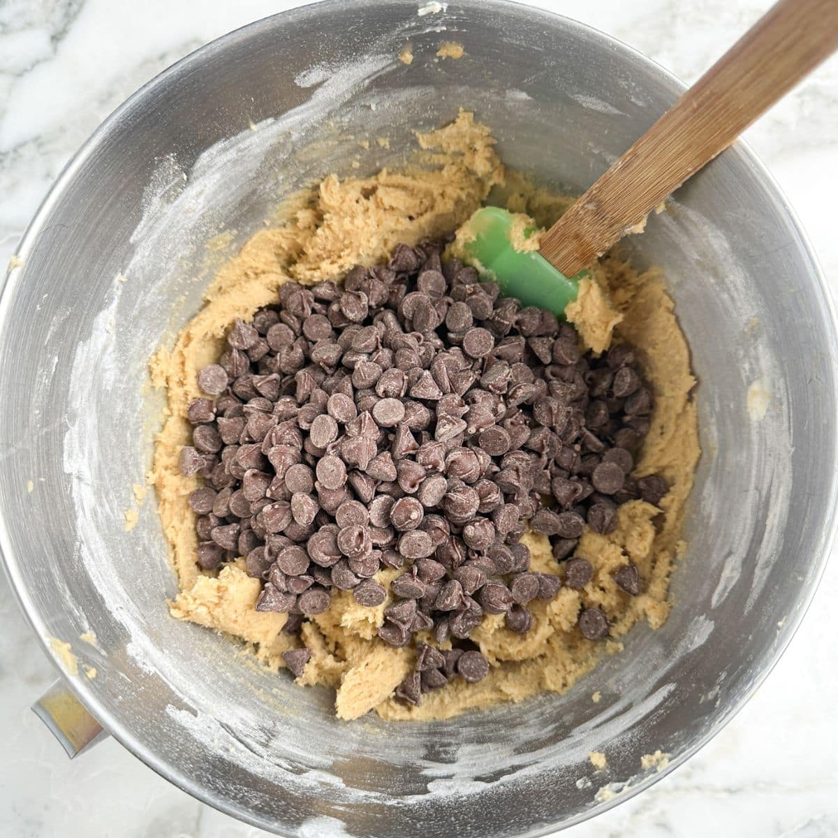 Mixing bowl with cookie dough and chocolate chips.