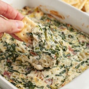 Cracker with spinach artichoke dip.