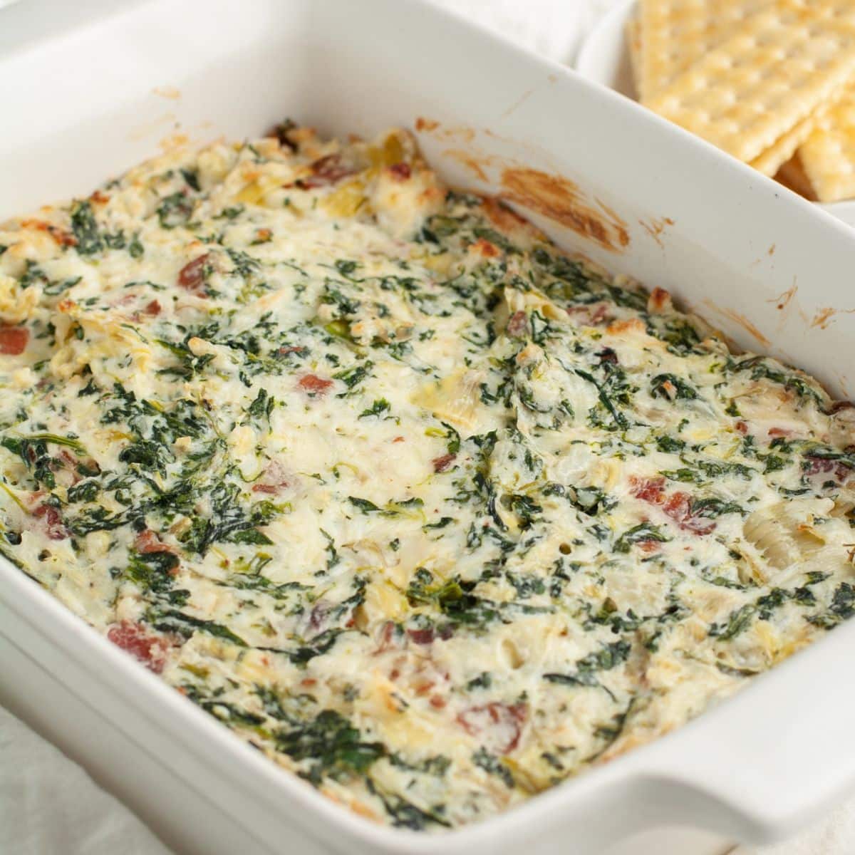 Baking dish with spinach artichoke dip.