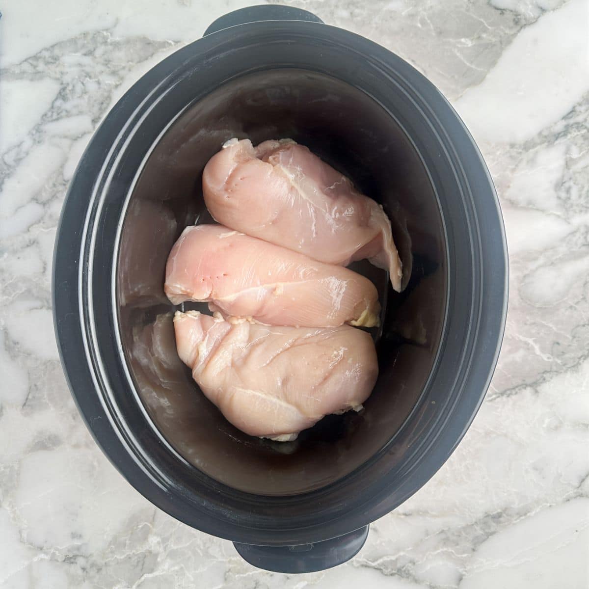 Chicken breasts in a slow cooker. 