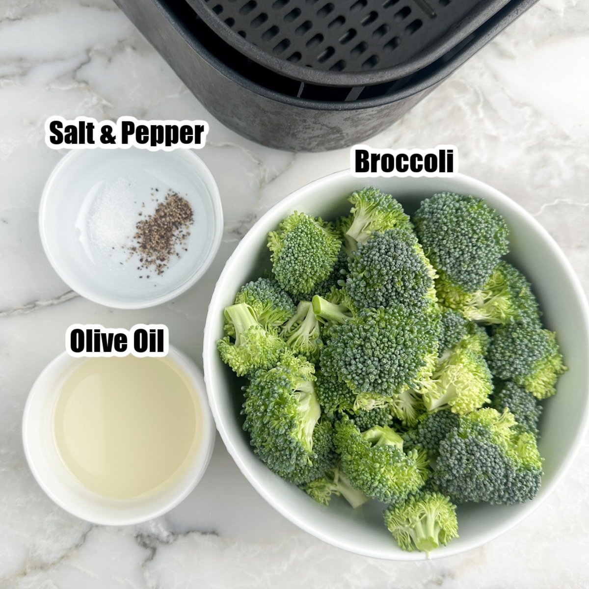 A bowl of broccoli florets, olive oil, and seasonings. 