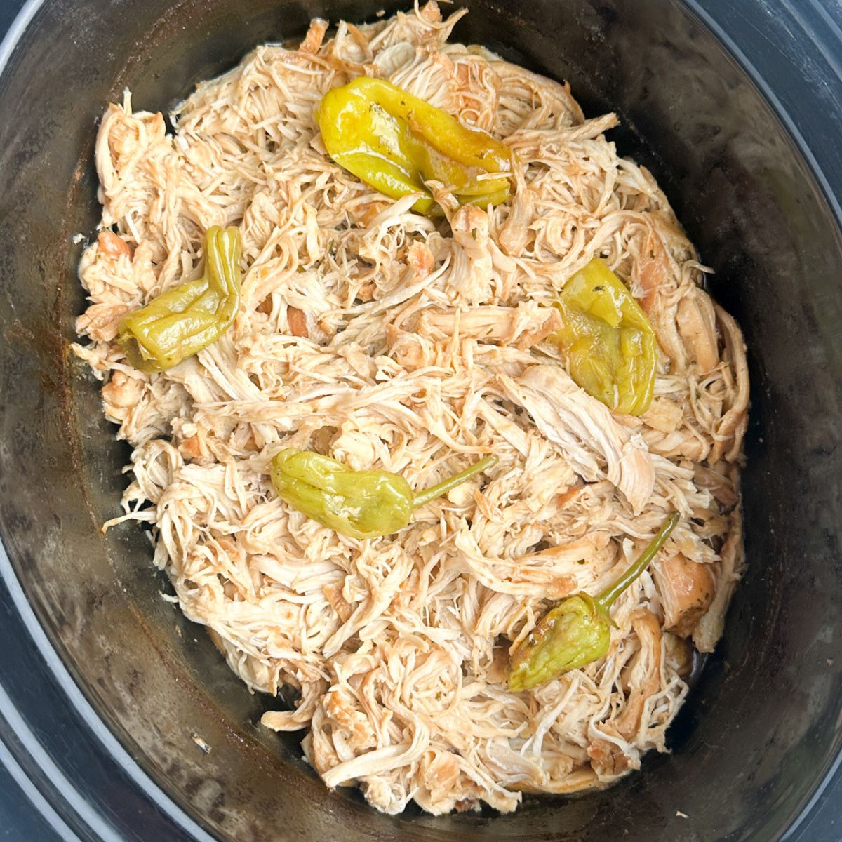 Slow cooker with shredded chicken. 