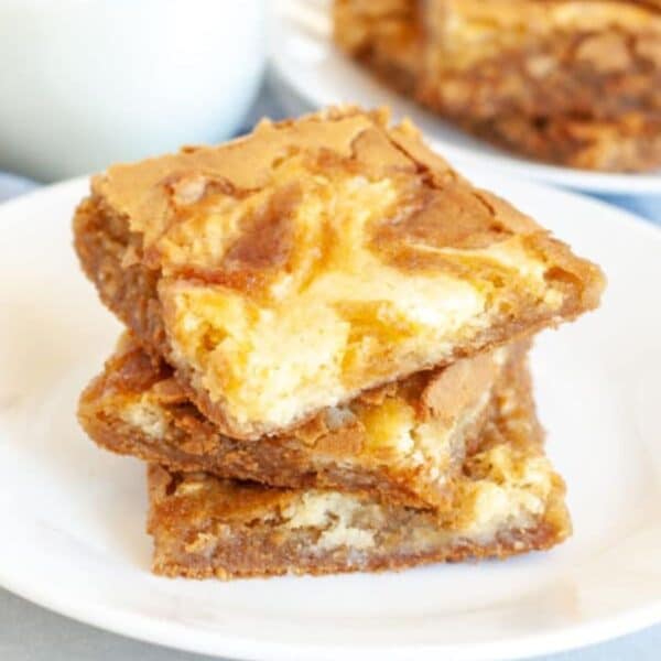 Stack of cream cheese blondies.