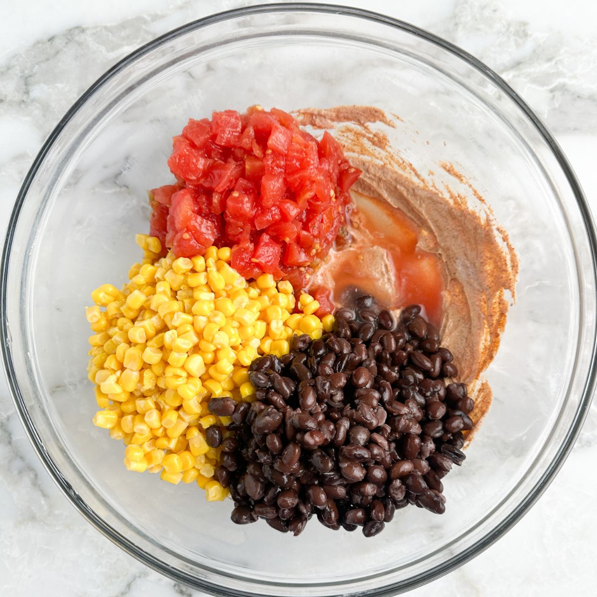 Bowl with corn, black beans, and diced tomatoes. 