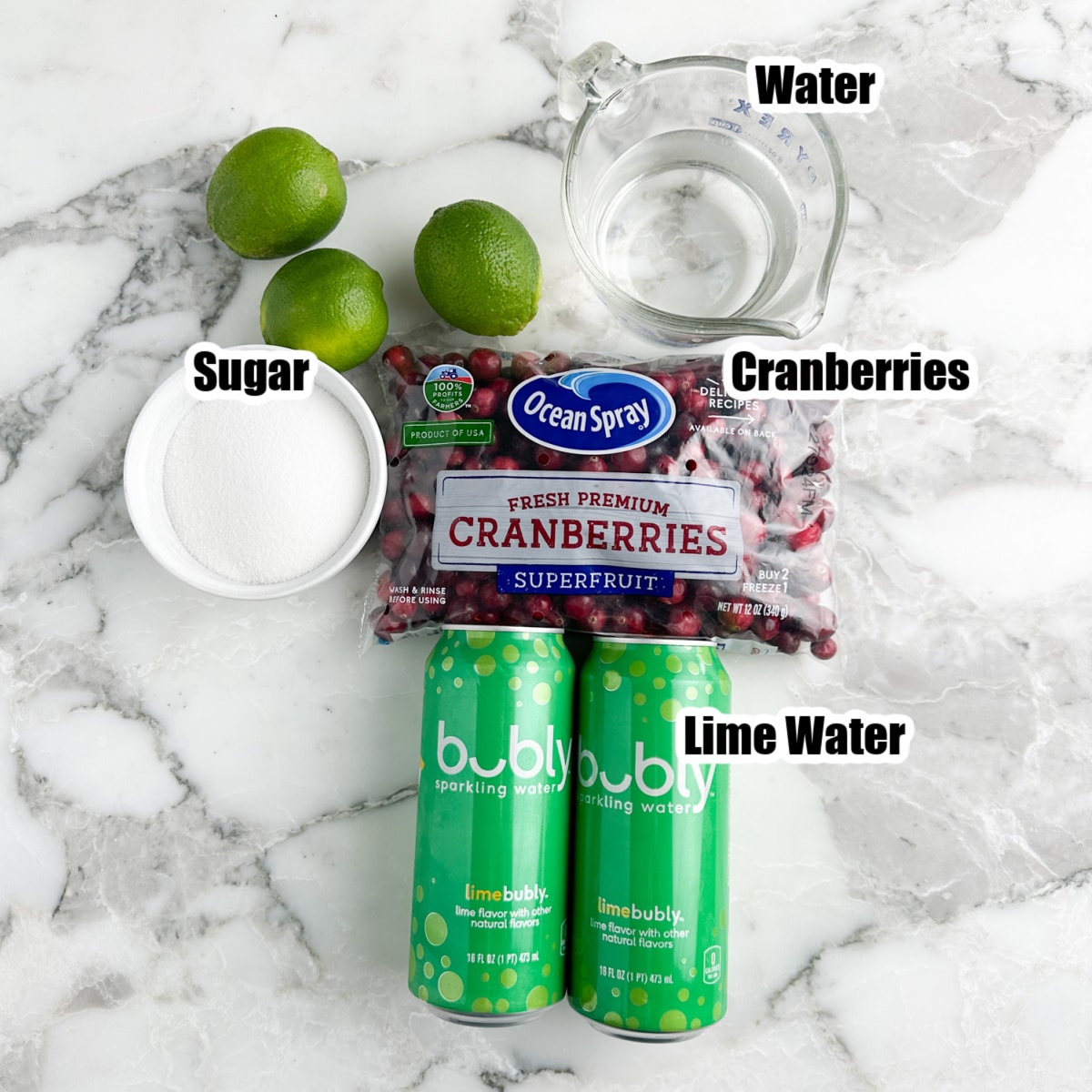 Cans of sparkling water, bowl of sugar, cranberries, and water. 