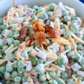 Bowl with peas, cheese and bacon.