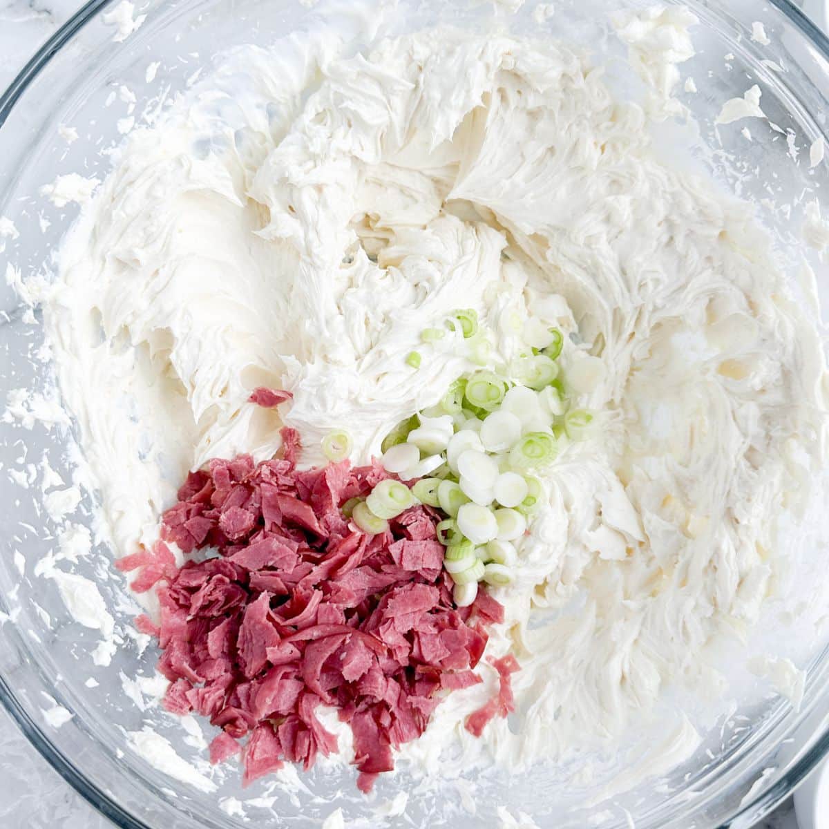 Bowl of cream cheese, diced onions, and diced chipped beef. 