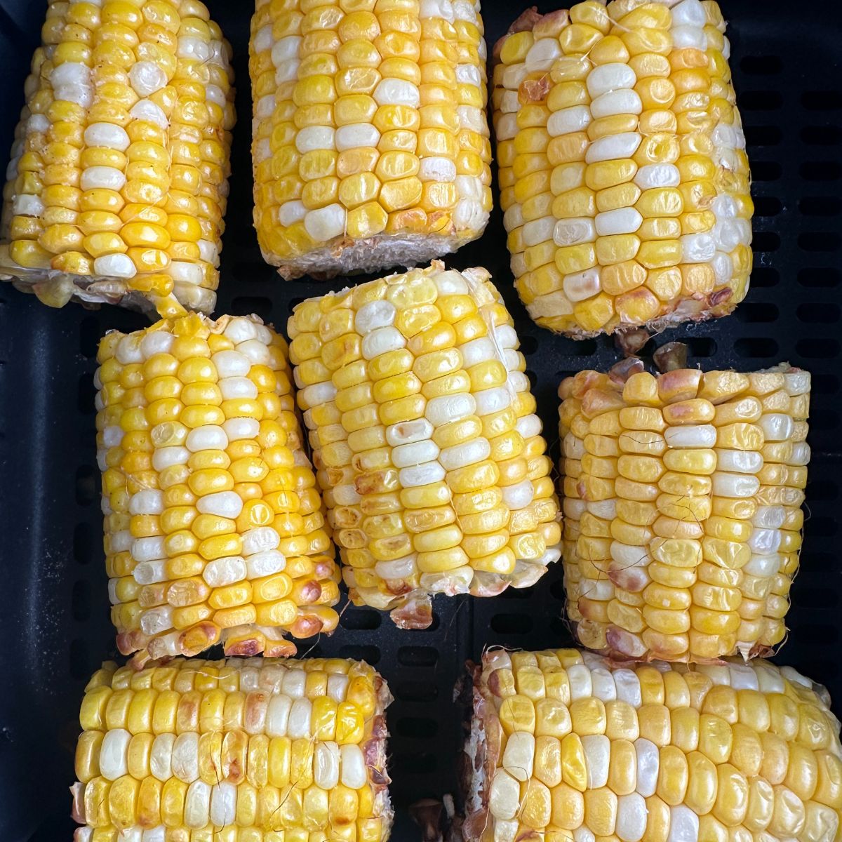Corn in air fryer basket.