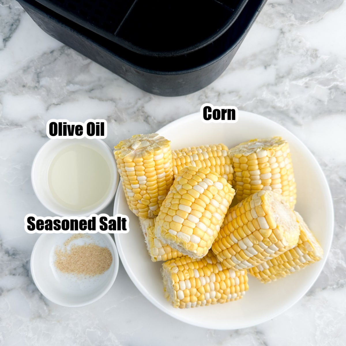 Bowl of corn, bowl of olive oil and seasoning salt. 