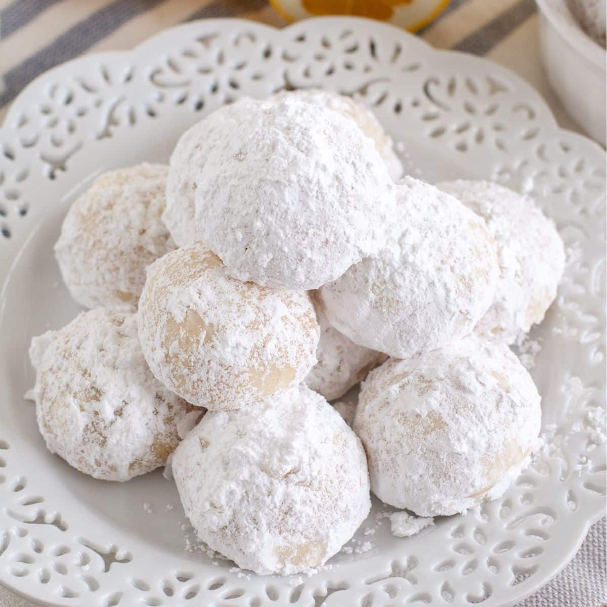 Plate of powdered sugar lemon snowball cookies.