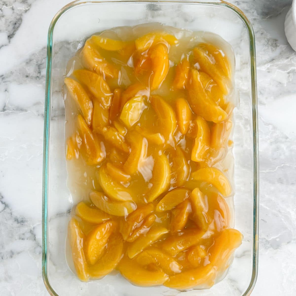 Casserole dish with peach pie filling. 