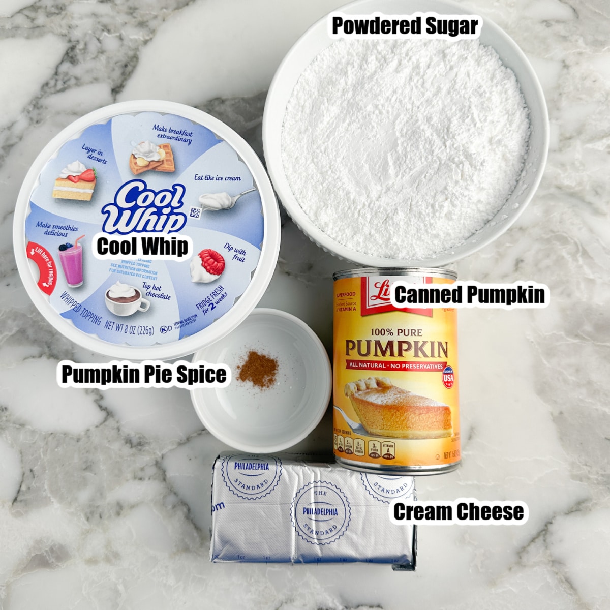 Cool Whip, bowl of powdered sugar, bowl of pumpkin pie spice, canned pumpkin, cream cheese. 