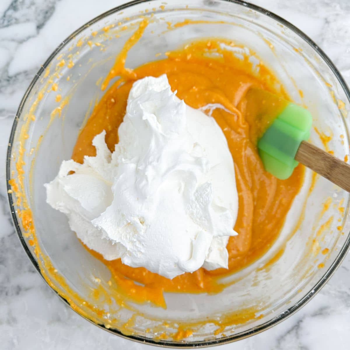 Bowl with canned pumpkin and Cool Whip. 