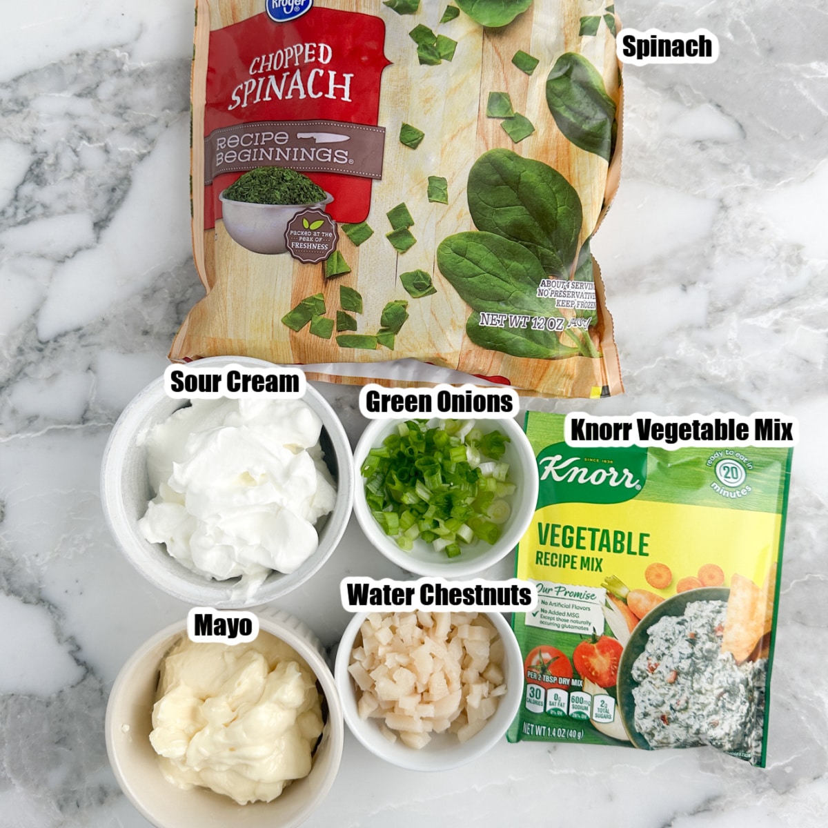 Bowl of sour cream, mayonnaise, bag of frozen spinach, and Knorr vegetable mix. 