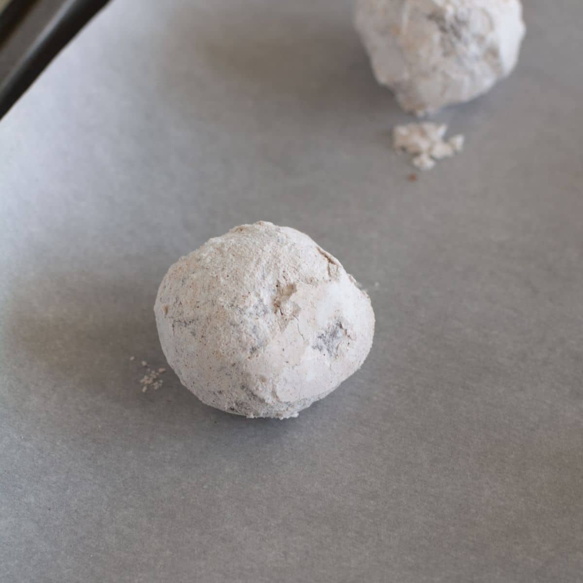 Cookie dough balls on a baking sheet. 