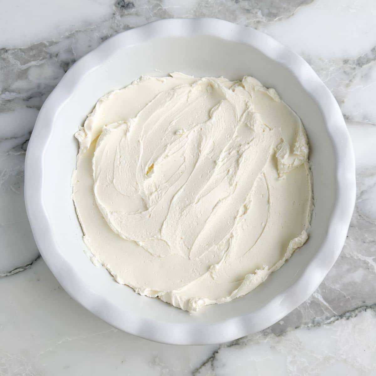 Cream cheese spread in pie dish.