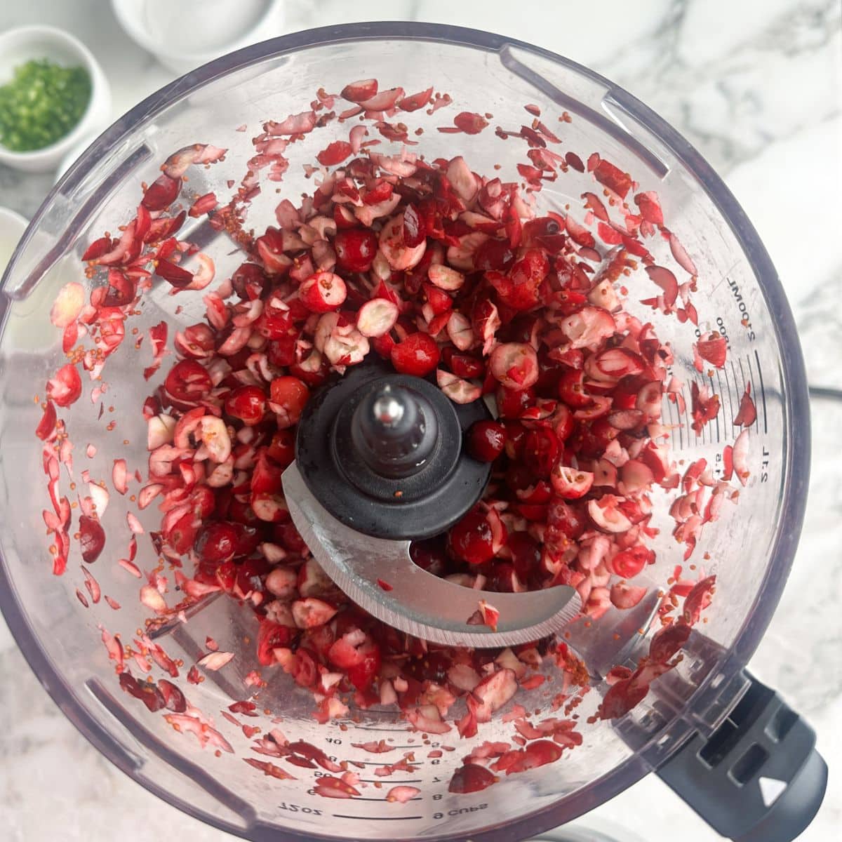 Food processor with chopped cranberries. 