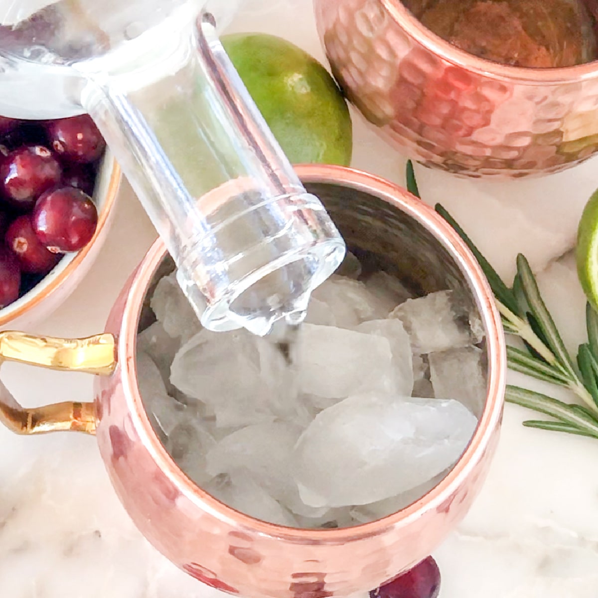 Vodka pouring into a glass with ice.