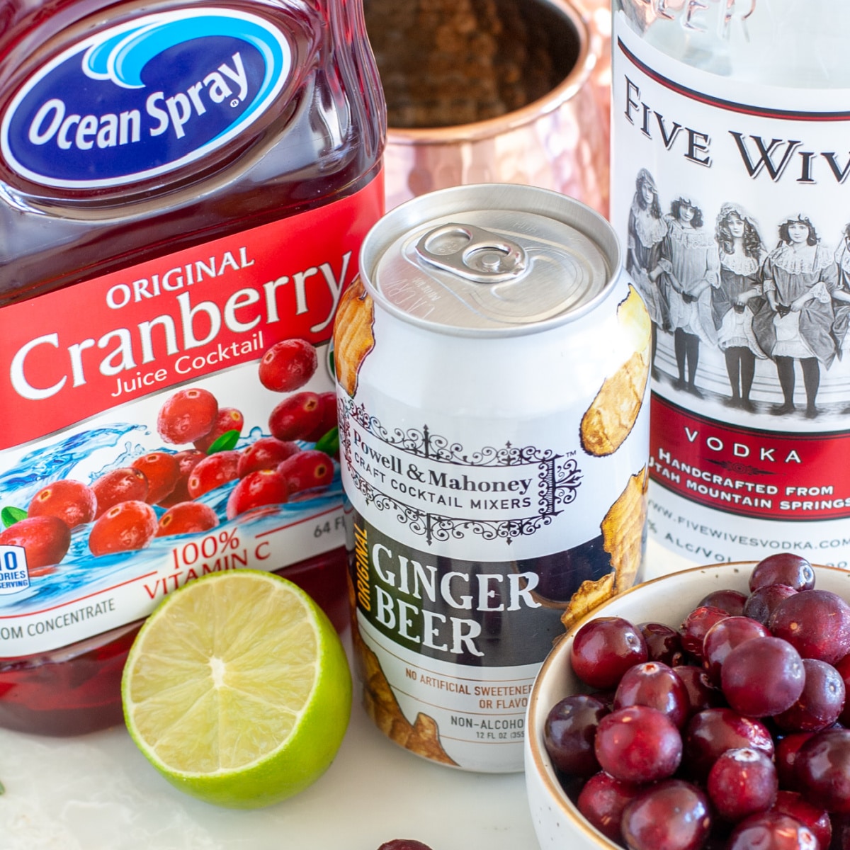 Bottle of cranberry juice, ginger beer, and vodka.