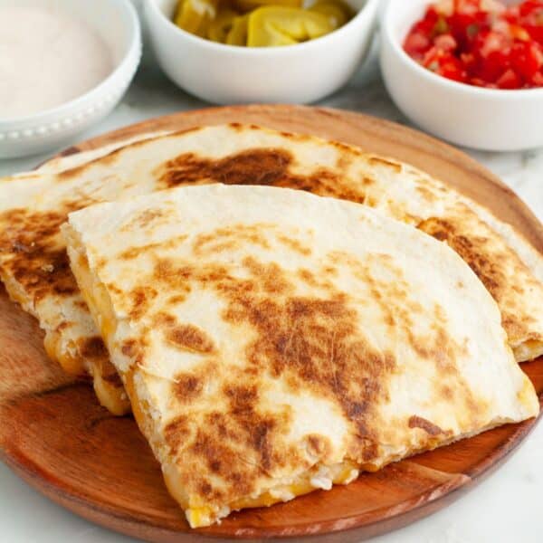 Quesadilla on a wooden plate.