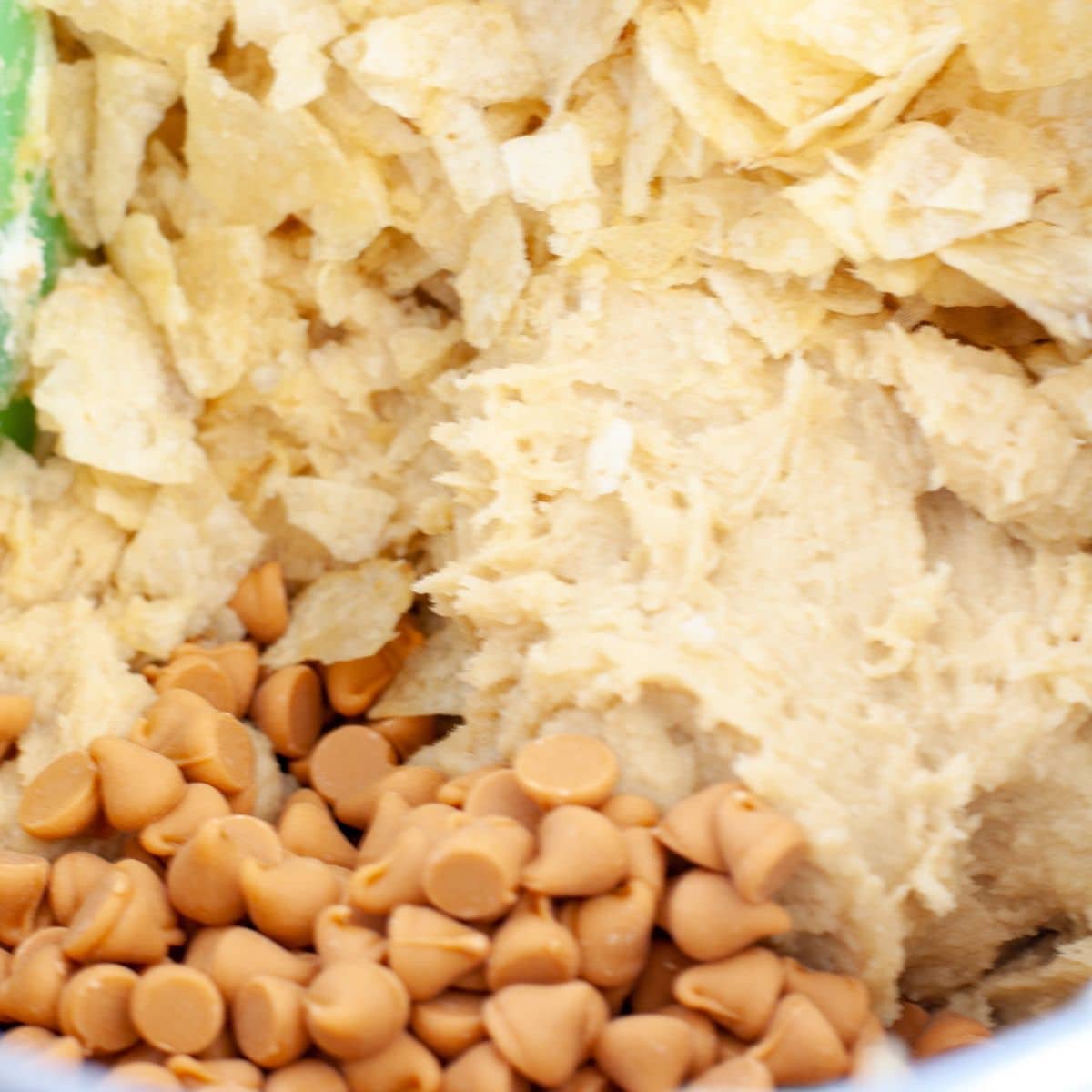 Bowl of butterscotch chips, potato chips, and cookie dough. 