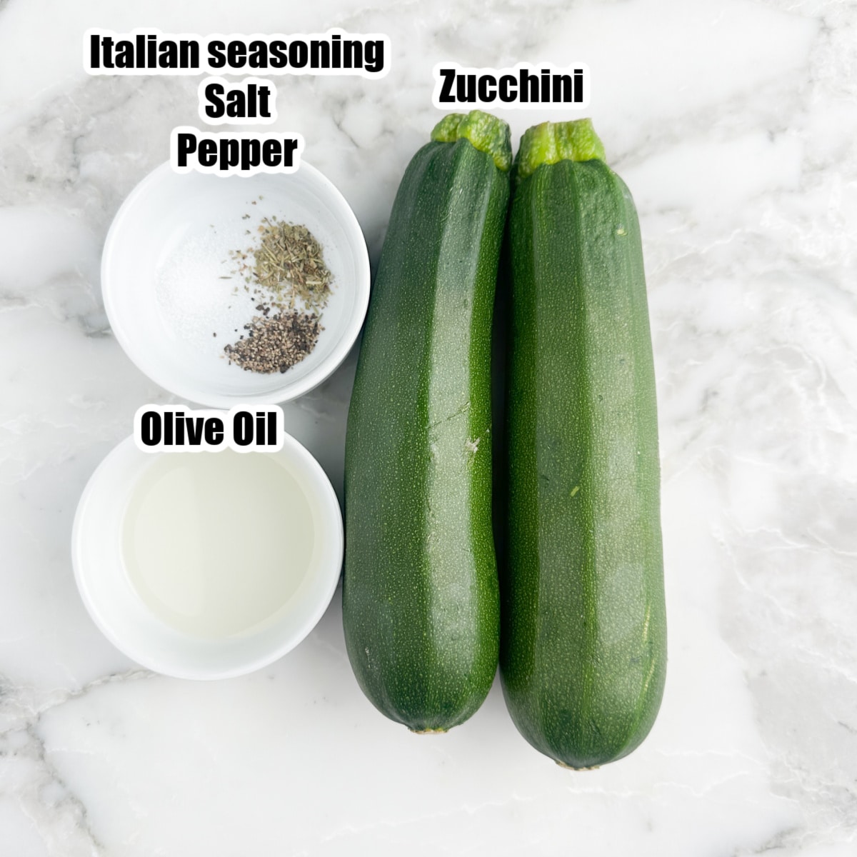 2 zucchinis, bowl of olive oil and seasonings. 