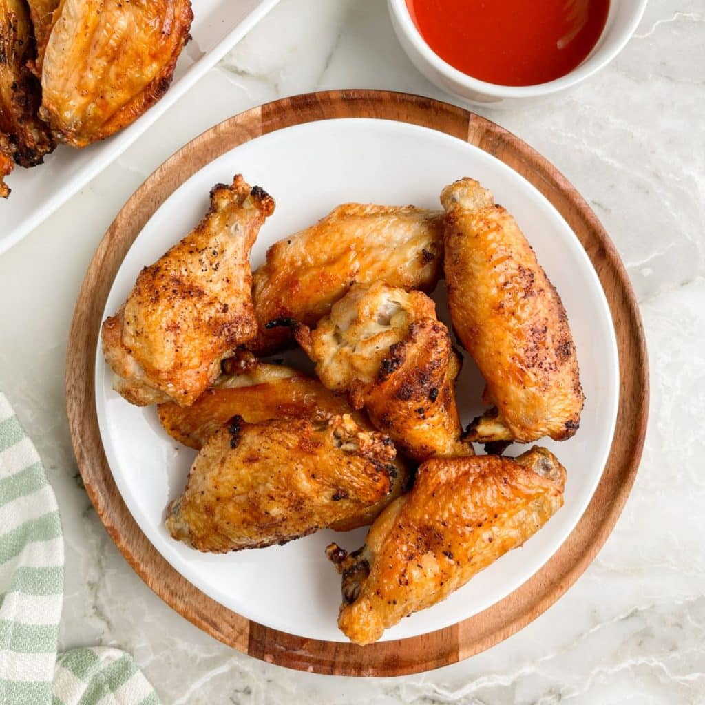 https://www.foodlovinfamily.com/wp-content/uploads/2022/11/how-long-to-bake-chicken-wings-1024x1024.jpg