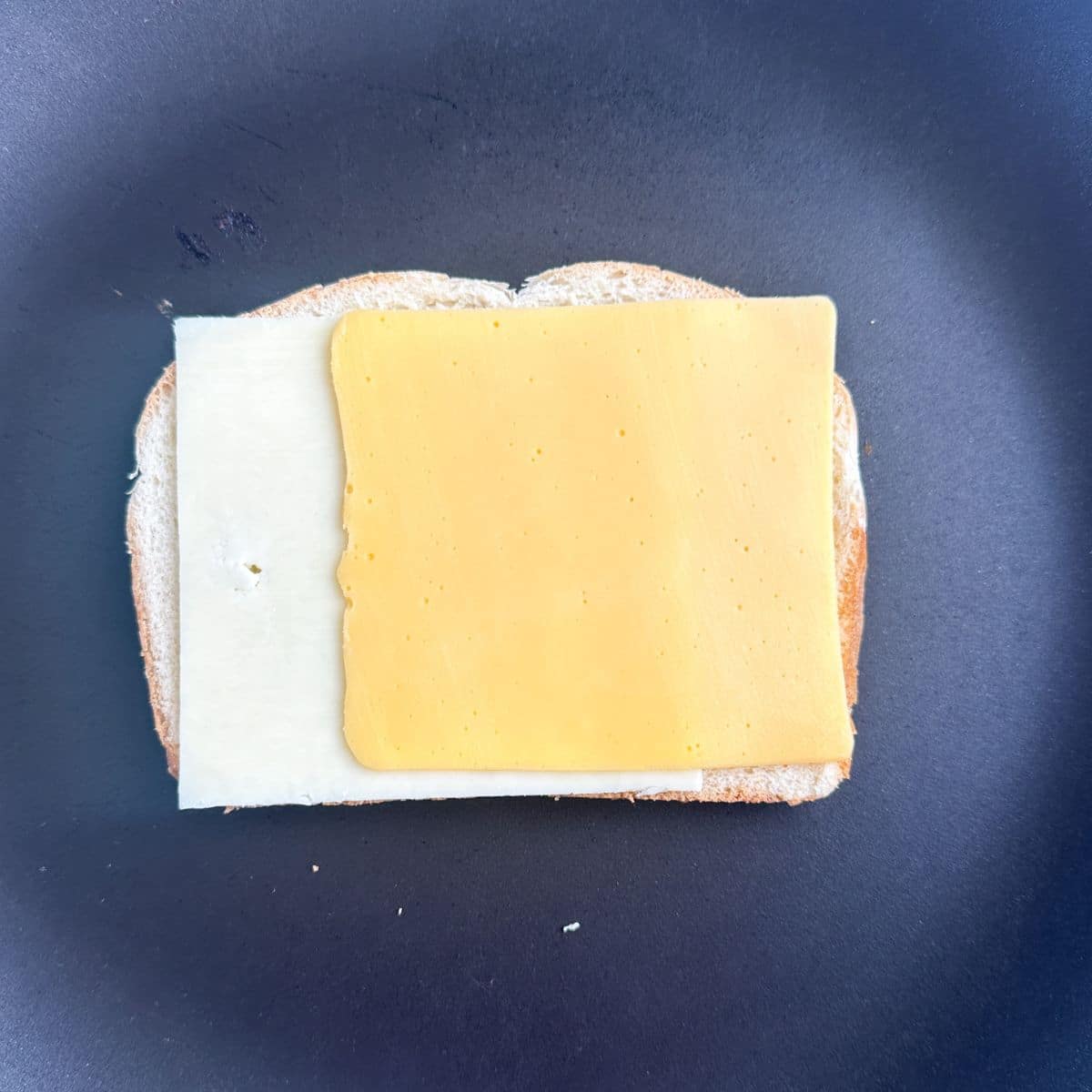 Slice of bread topped with cheese. 