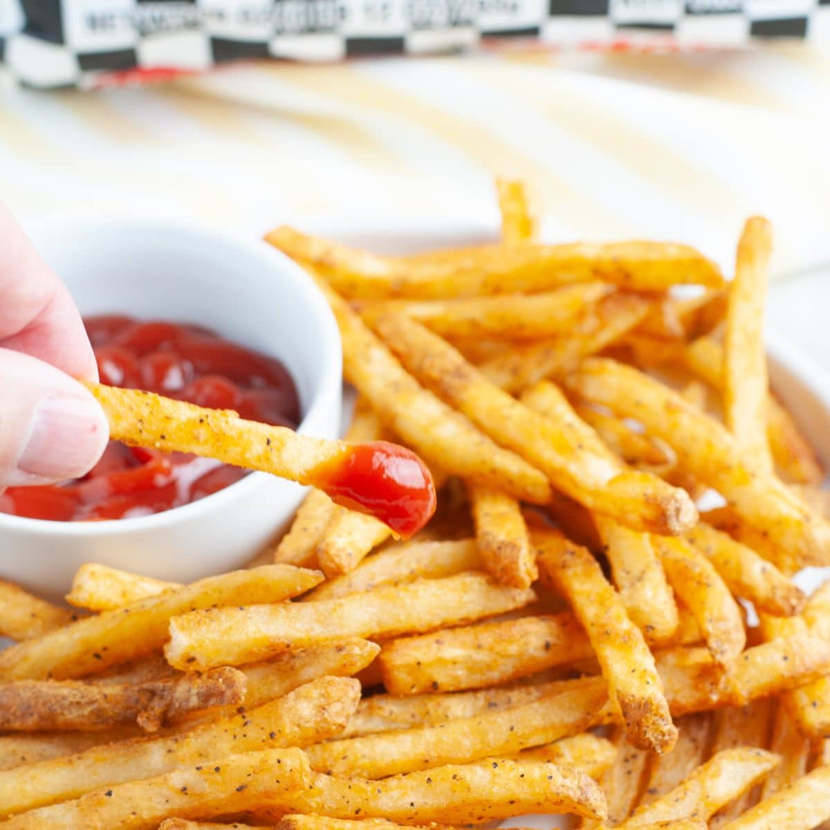 French fries dipped in ketchup. 