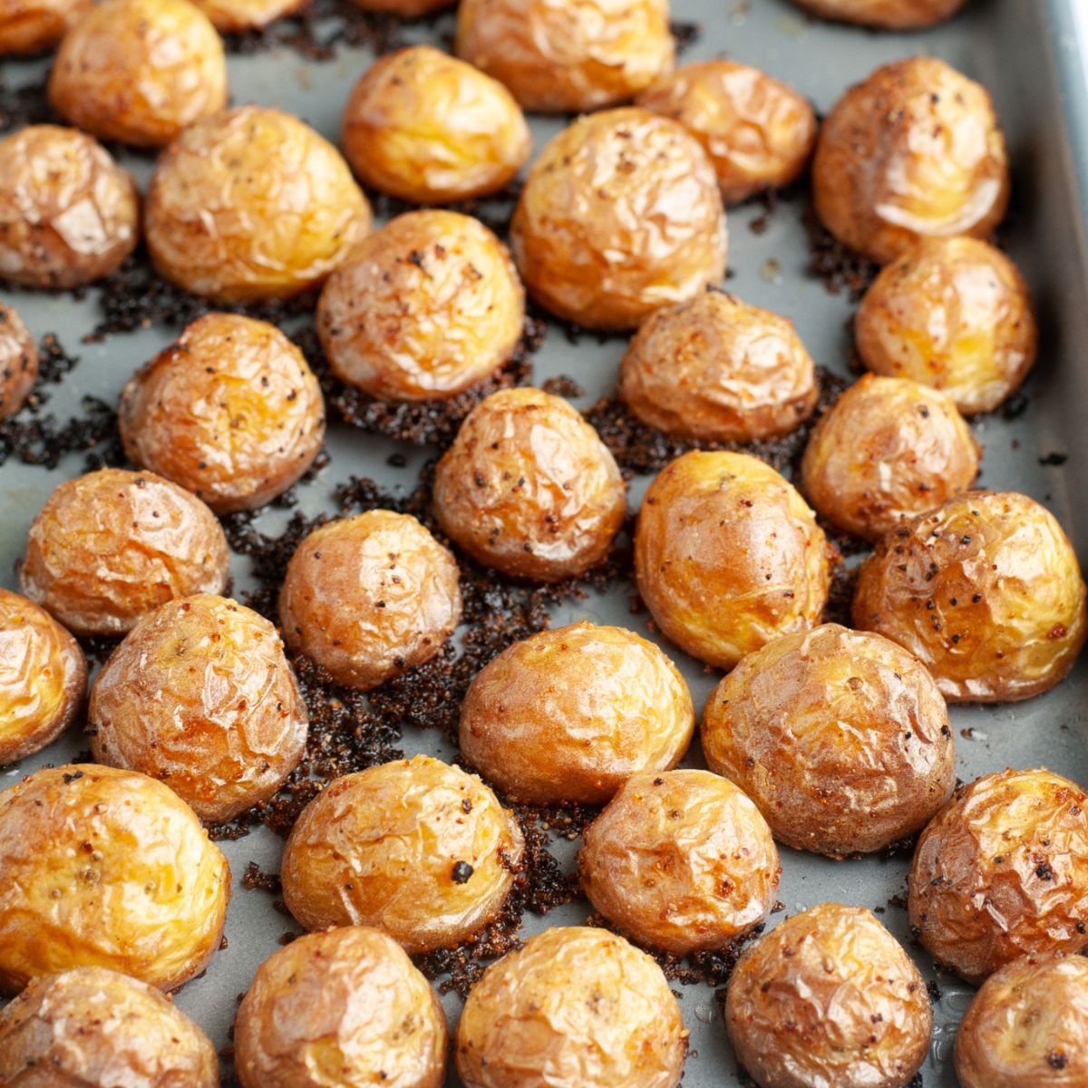 Baking sheet with roasted potatoes. 