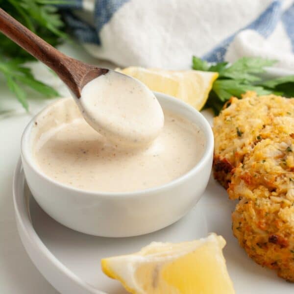 Bowl of crab cake sauce with crab cakes.