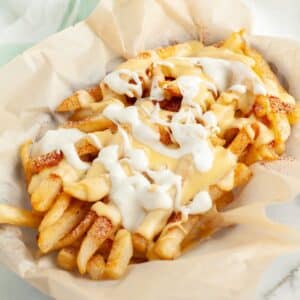 Basket of voodoo fries with cheese sauce and ranch.