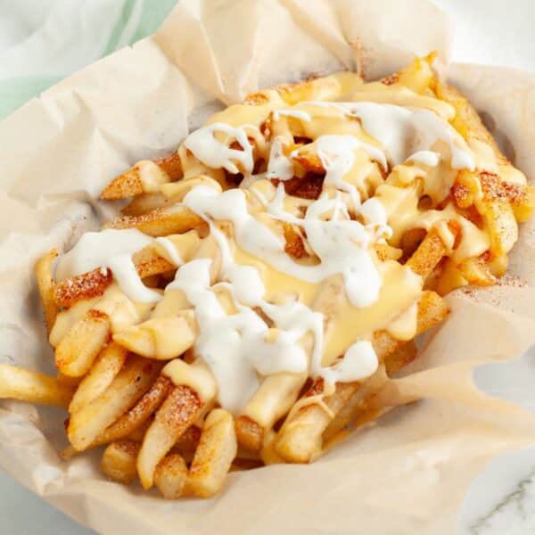 Basket of voodoo fries with cheese sauce and ranch.