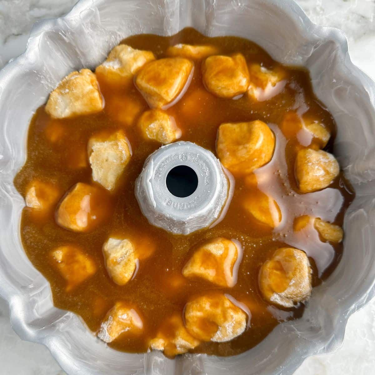 Bundt pan with biscuit dough and butterscotch sauce.