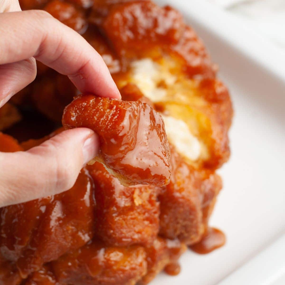 Hand holding a piece of monkey bread.