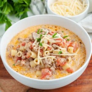 Bowl of creamy soup with sausage and pasta.