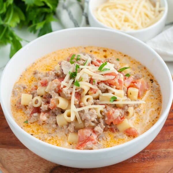 Bowl of creamy soup with sausage and pasta.