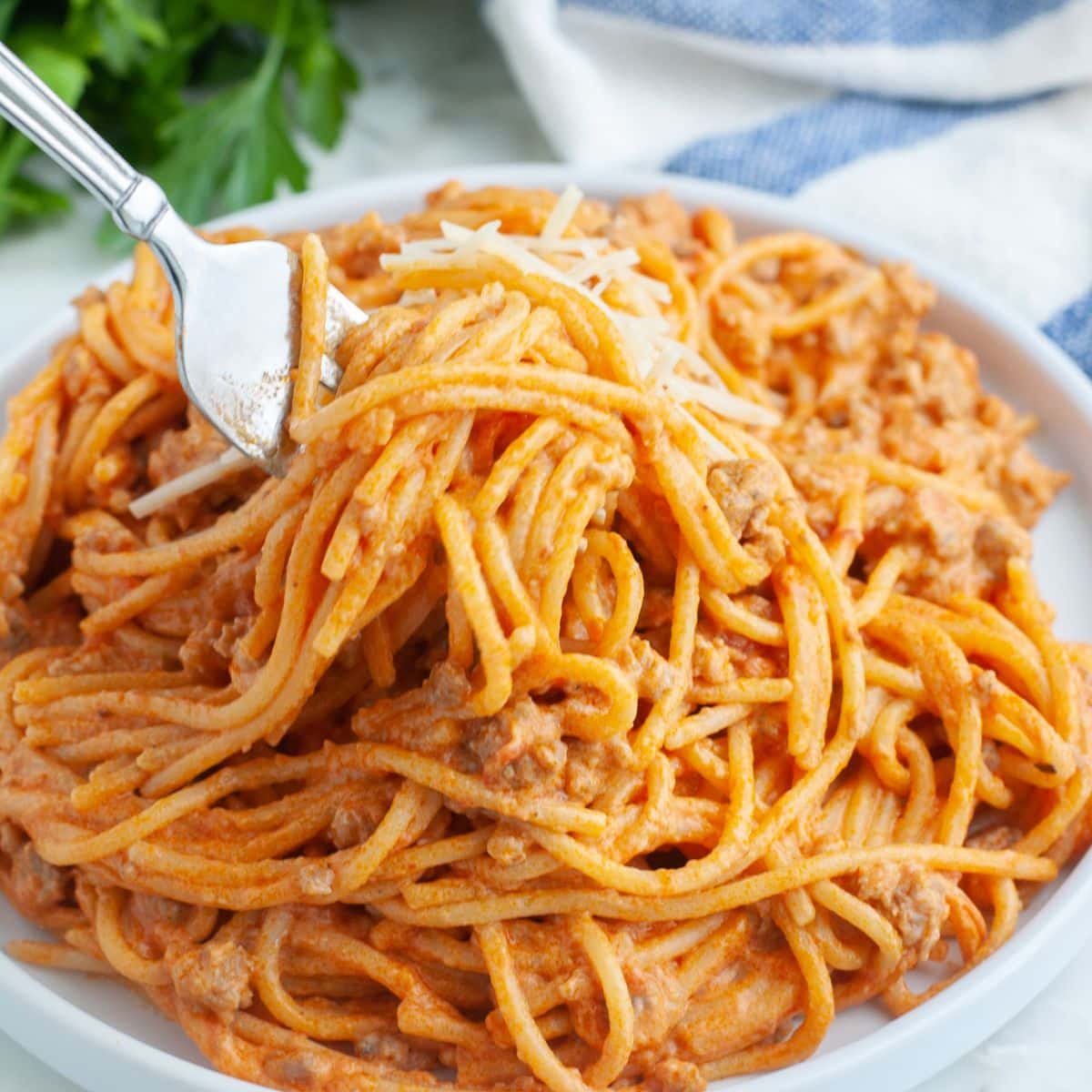 Fork in creamy spaghetti. 