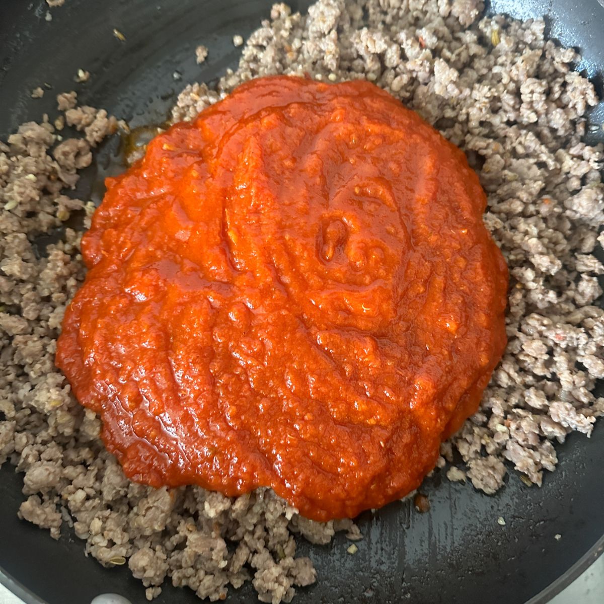 Ground sausage with marinara sauce.