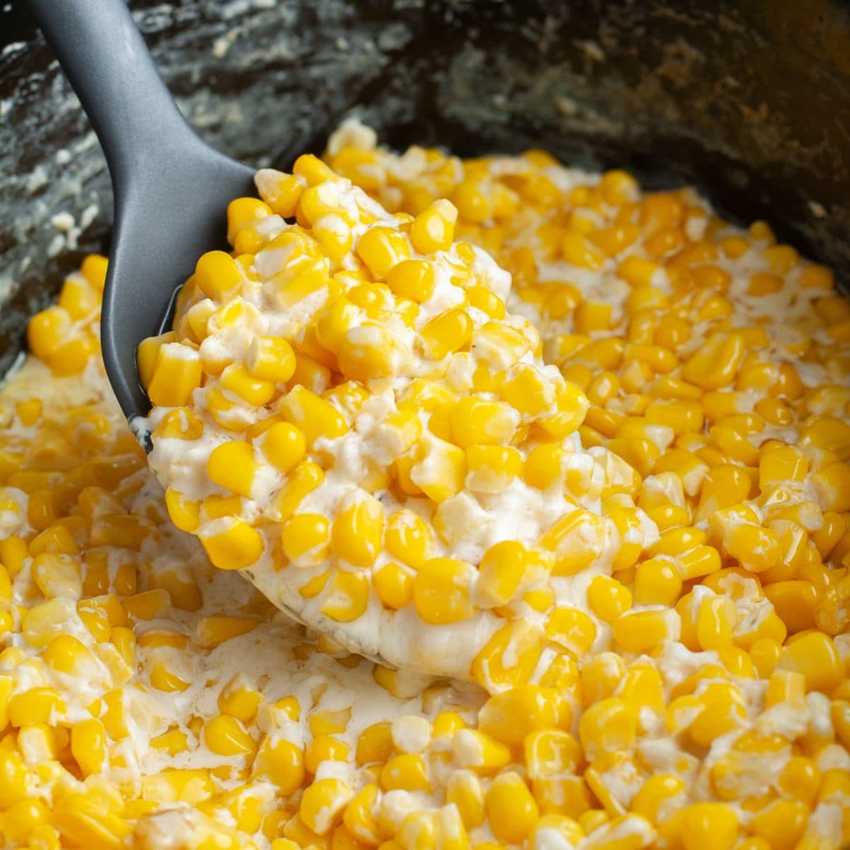 Spoon with creamy corn.