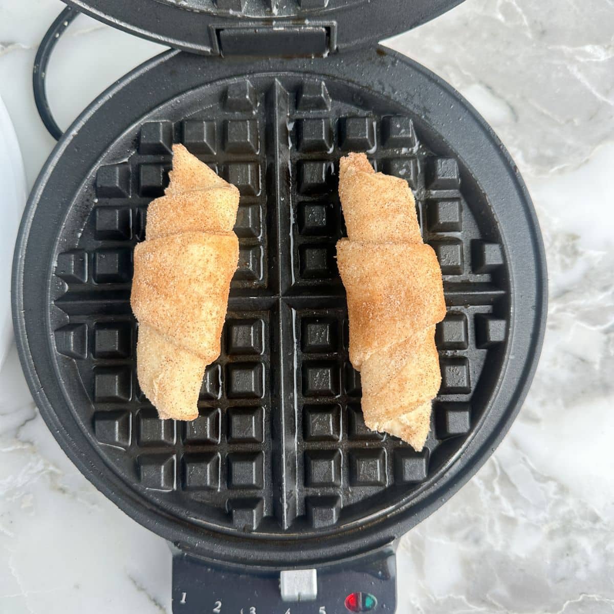 Crescent rolls on a waffle iron.