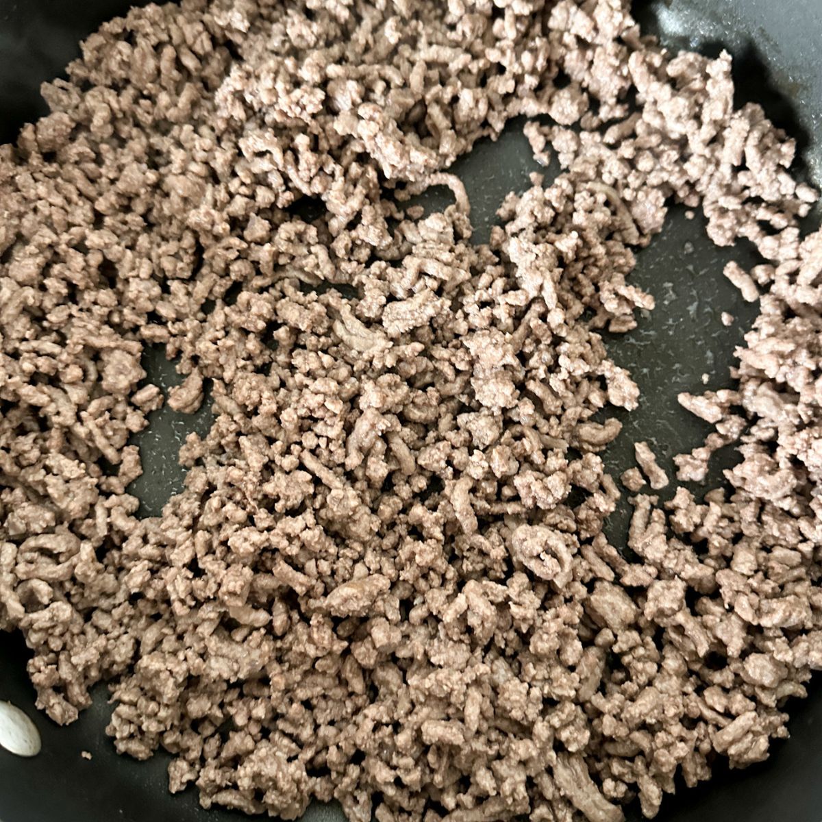 Ground beef in a skillet.