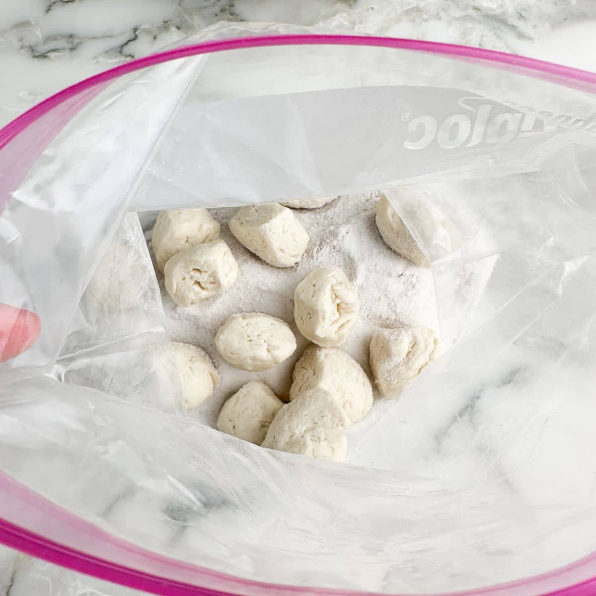 Bag with biscuit dough balls and sugar.